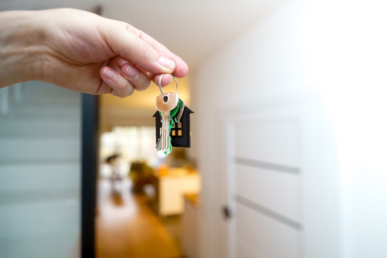 home-img A hand holding house keys inside a modern apartment, symbolizing new property ownership or rental.