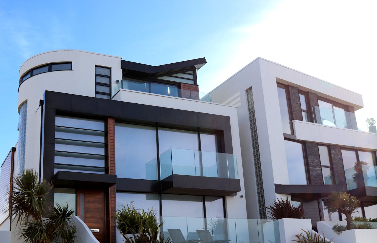 services-img Contemporary luxury home with glass balconies in Poole, UK, showcasing modern architectural design.