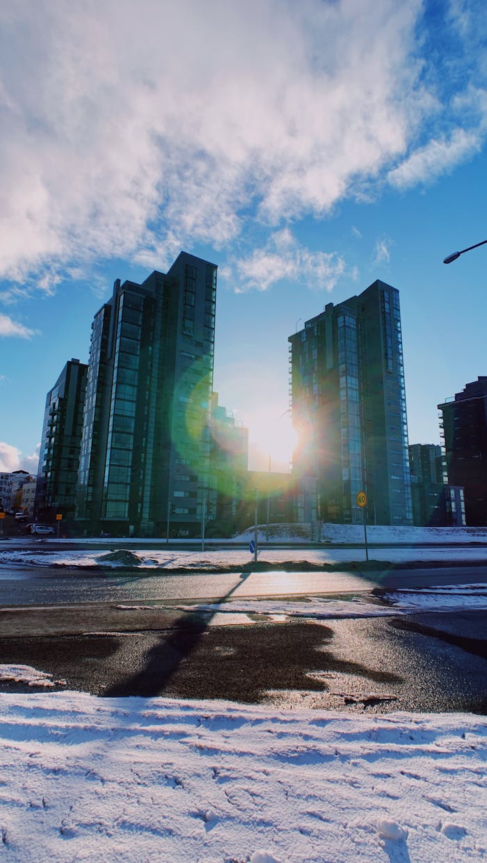 about-img-01 From below of contemporary skyscrapers and office buildings located on city district near snowy road in winter day in sunny weather